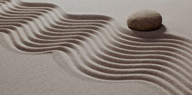 zen garden with stone and rippled sand