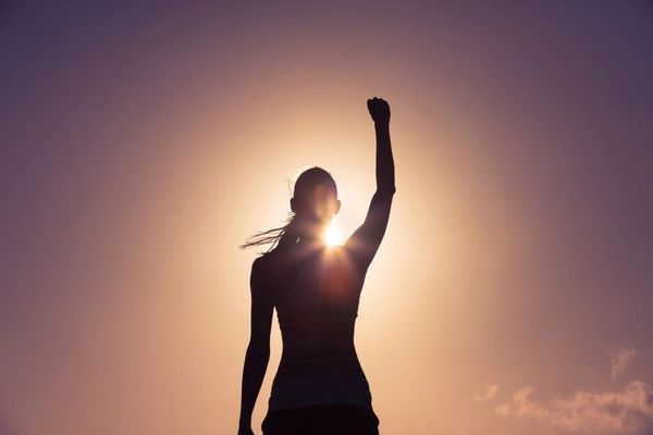 Woman raising her hand toward the sky