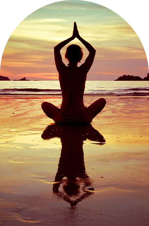 Woman doing yoga on the beach